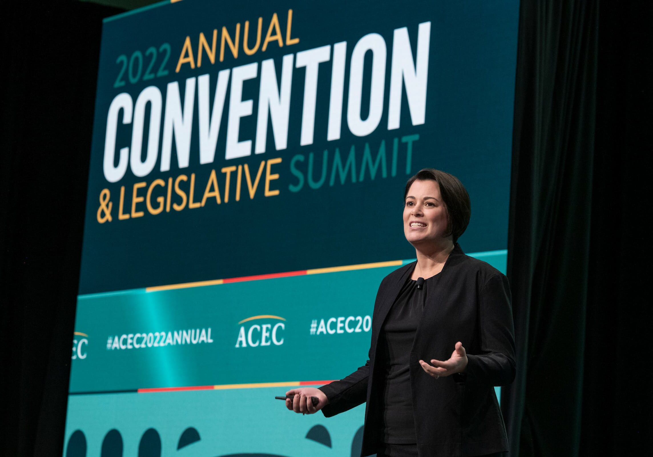 ACEC8803-1238 Lady speaking on the stage during the 2022 annual convention and legislative summit