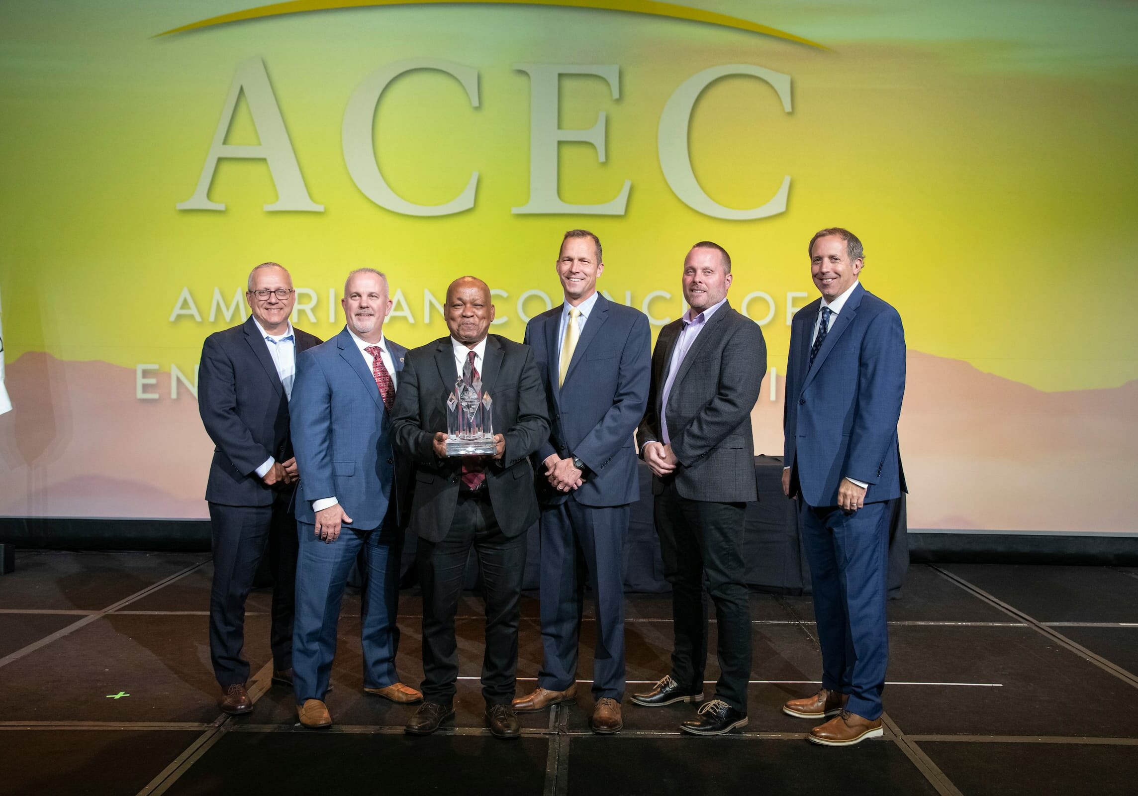 ACEC8836-2841 acec members standing on stage during awarding