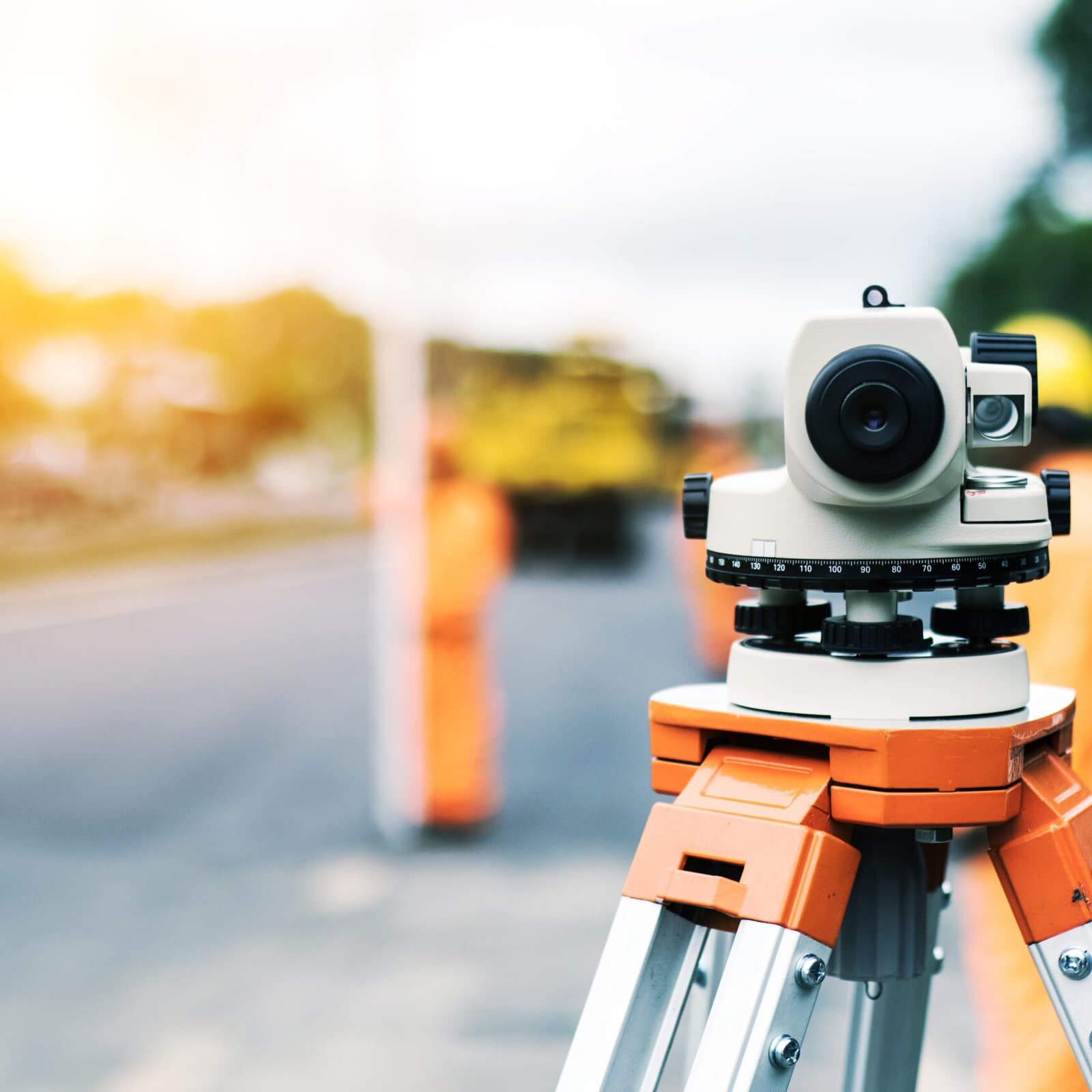 Surveyor’s telescope at new road construction site Surveyor’s telescope at new road construction site