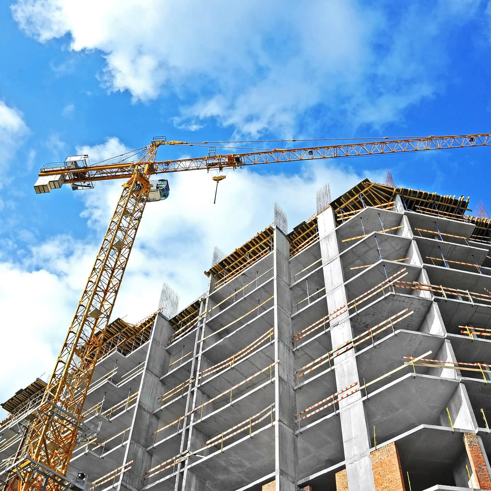 Crane,And,Building,Construction,Site,Against,Blue,Sky Crane And Building Construction Site Against Blue Sky
