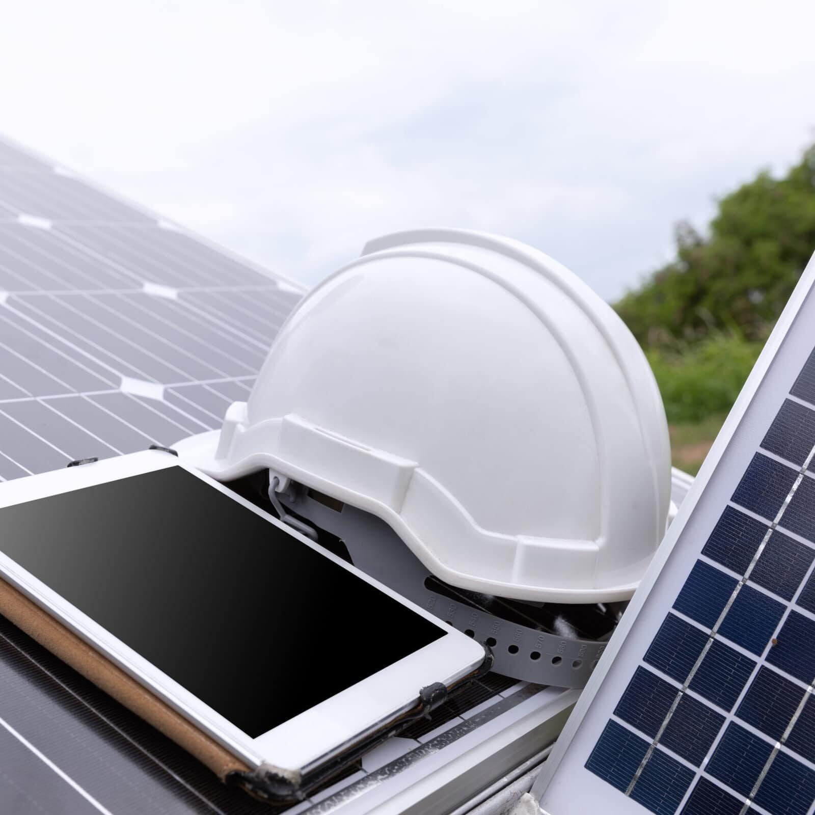 Engineer solar photovoltaic panels station checks with tablet co Engineer solar photovoltaic panels station checks with tablet computer.