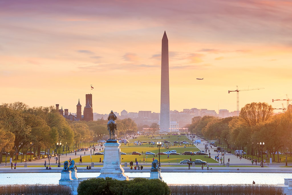 Washington DC city view at a orange sunset, including Washington Washington DC city view at a orange sunset, including Washington Monument from Capitol building